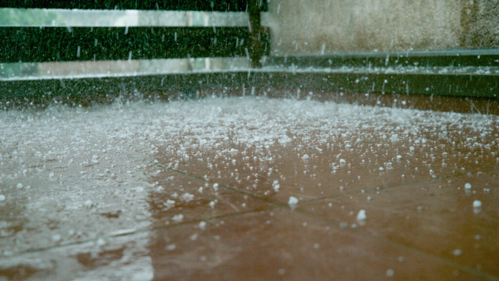 a fire hydrant spewing out water on a rainy day - Forensic Roof Testing