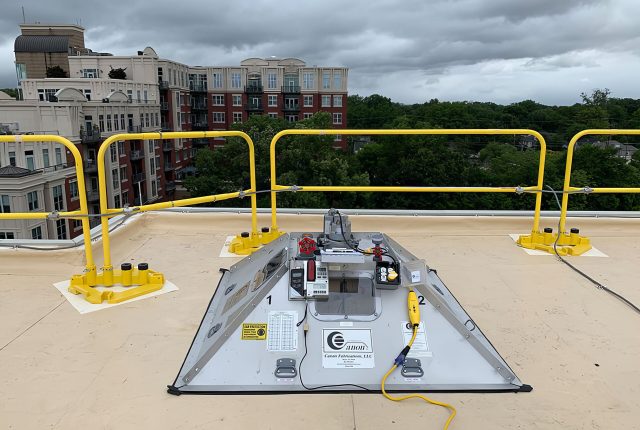 a view of a building with a roof testing machine on it